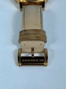 Burberry watch strap with gold buckle.
