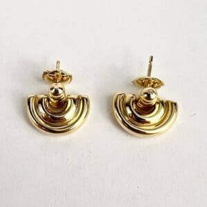 Gold crescent-shaped earrings on white background.