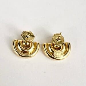 Gold half-moon earrings on white background.