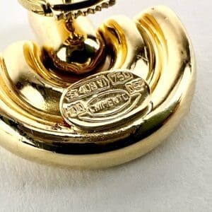 Gold metal fixture with engraved label.