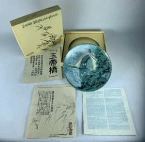 Decorative plate with box and documents.