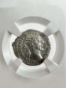 Ancient coin in protective display holder.