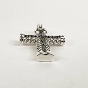 Silver cross pendant with black stones.