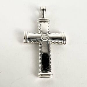 Silver cross pendant with engraved details.