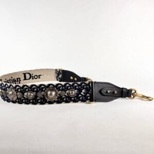 Decorative black leather strap with metal accents.