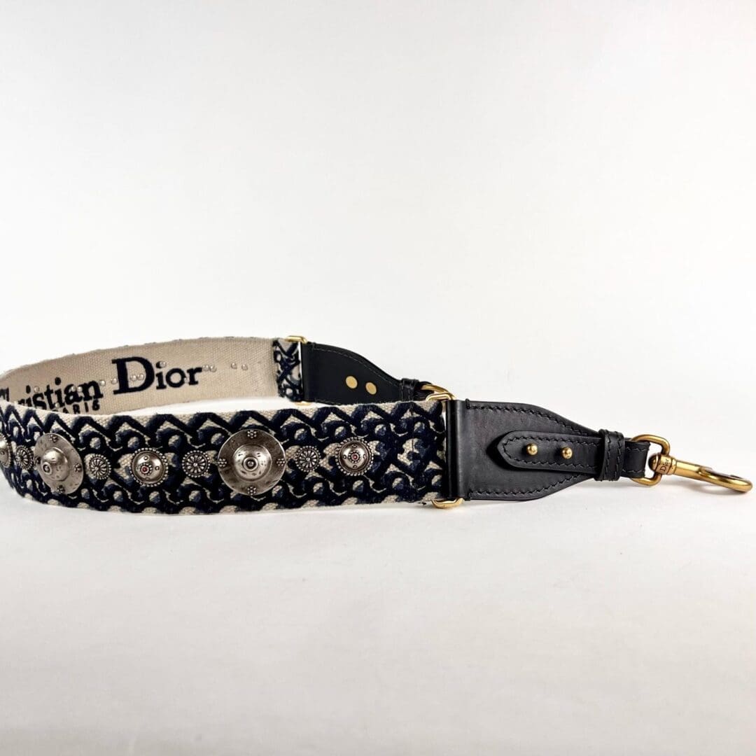 Decorative black leather strap with metal accents.