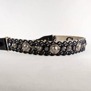Patterned belt with decorative metal accents.