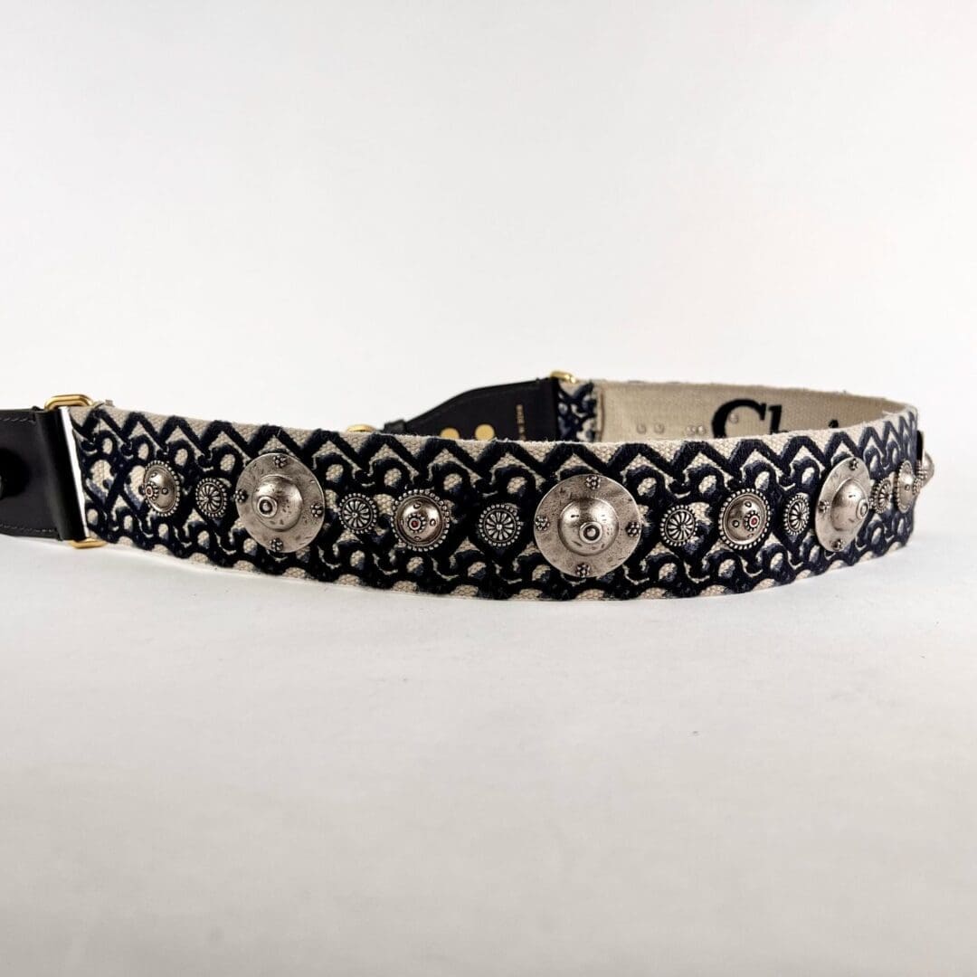 Patterned belt with decorative metal accents.