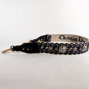 Designer strap with decorative floral details.