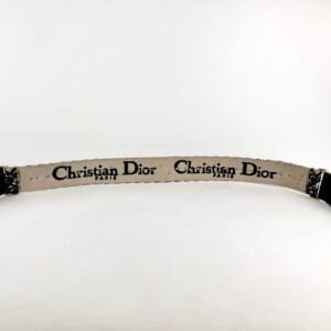 Christian Dior strap on white background.