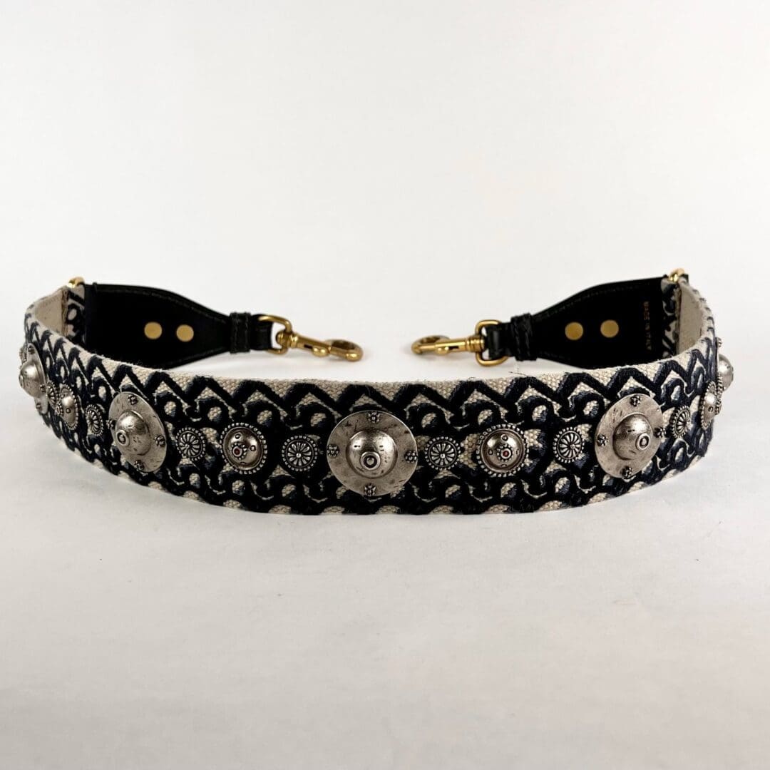 Decorative belt with ornate metal embellishments.