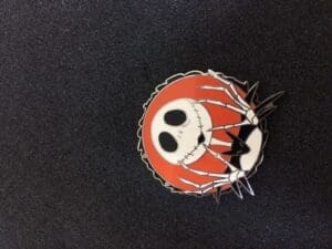 Jack Skellington pin on black surface.