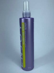 Purple clarifying spray bottle on white background.