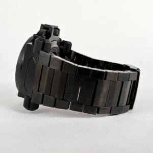 Black metal watch with linked bracelet.