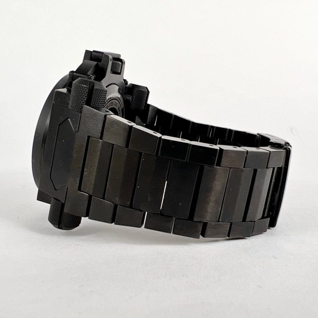 Black metal watch with linked bracelet.