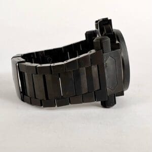 Black metal watch strap laid sideways.