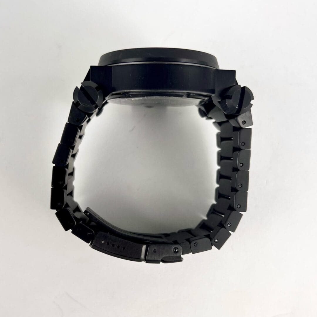 Black watch with metal bracelet, side view.