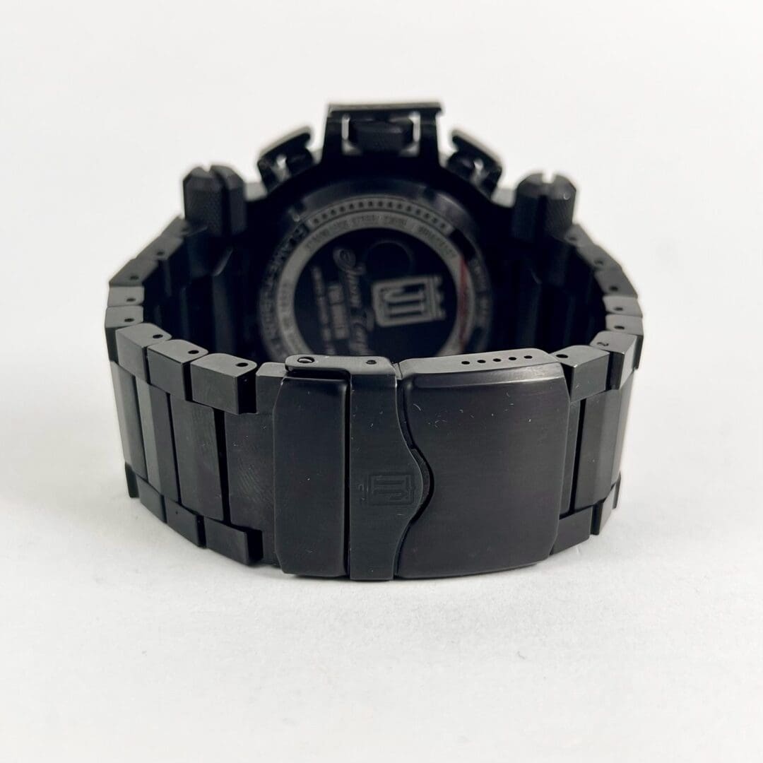 Black metal watch with closed clasp.