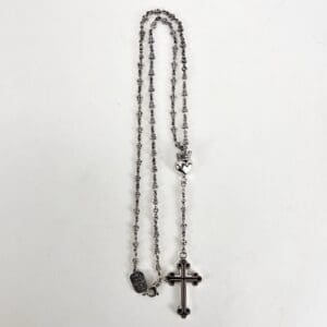 Silver rosary with cross and heart charms.