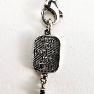 Silver tag with "Made in USA" engraving.