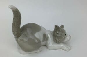 Ceramic figurine of a playful kitten.