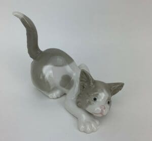 Gray and white ceramic cat figurine.