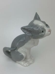 Gray and white ceramic cat figurine.