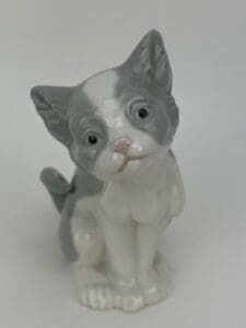 Ceramic figurine of a gray and white cat.
