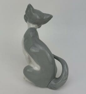 Gray and white ceramic cat figurine.