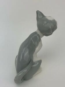 Gray and white ceramic cat figurine.