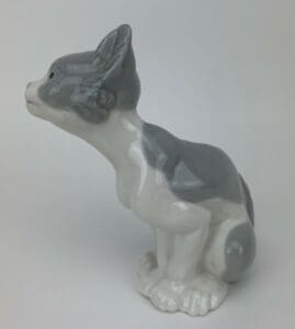 Gray and white ceramic cat figurine.