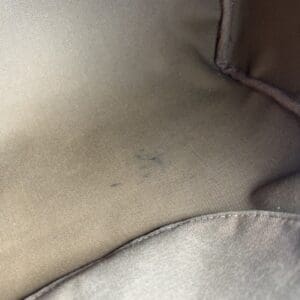 Brown fabric with small black marks.
