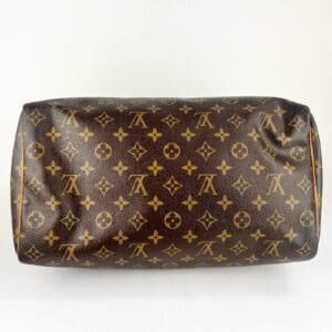 Brown designer bag with logo pattern.