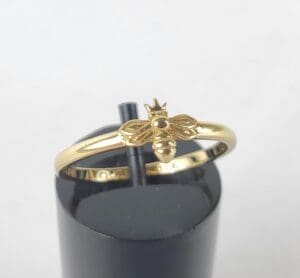 Gold ring with a bee design.