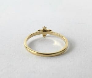 Gold ring with a small crown design.