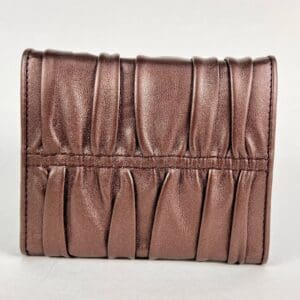 Brown leather wallet with pleated design.