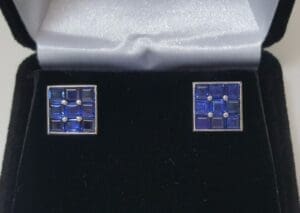 Square blue cufflinks in black velvet box.