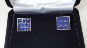 Square blue cufflinks in black velvet box.