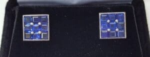 Square blue gemstone earrings in black box.