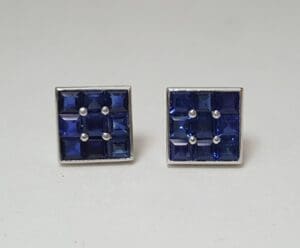 Square earrings with blue gemstones.