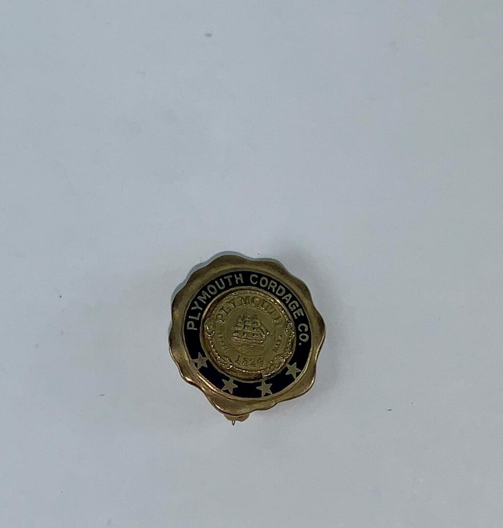 Plymouth Cordage Co. vintage pin badge.