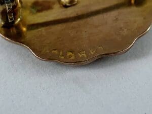 Close-up of a brass object with engraving.