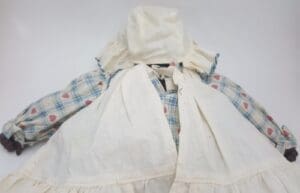 Old-fashioned doll in bonnet and dress.