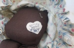 Heart-shaped label on fabric doll's body.