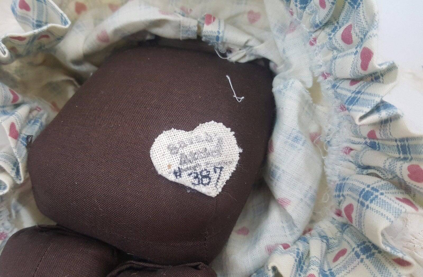 Heart-shaped label on fabric doll's body.