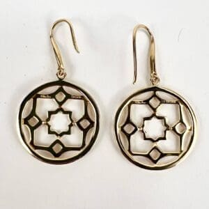 Gold geometric patterned circular earrings.