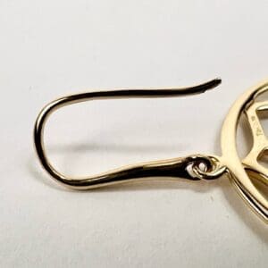 Gold earring with geometric design.