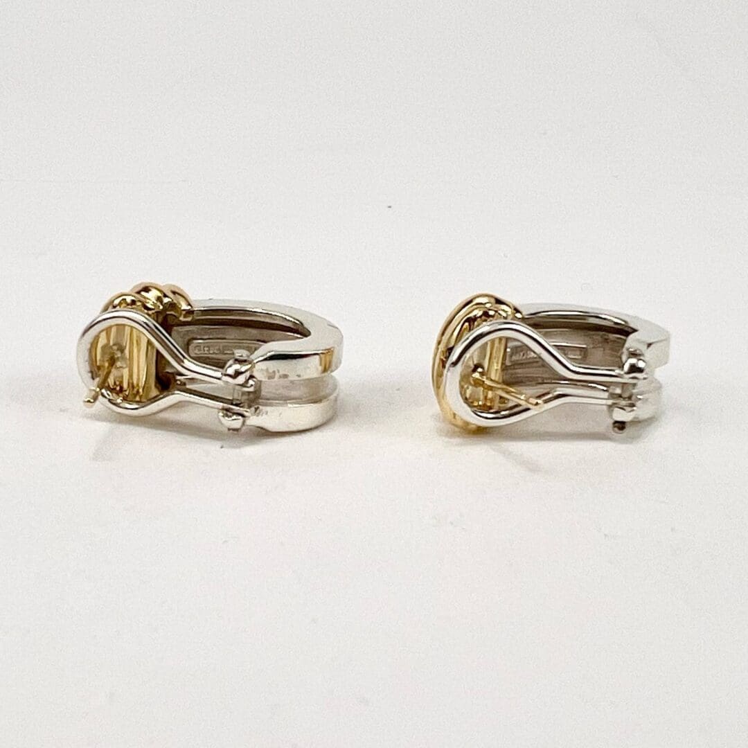 Silver and gold cufflinks on display.