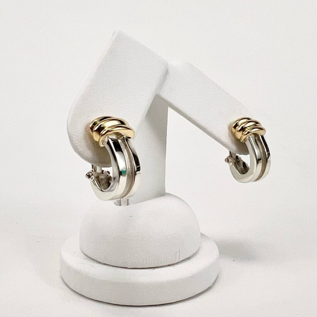 Gold and silver hoop earrings on display.
