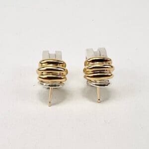 Gold and silver stacked hoop earrings.